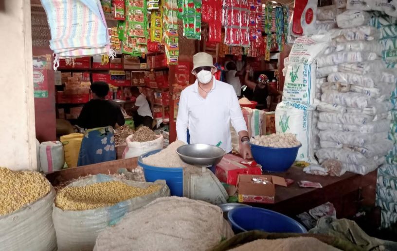 Francesco Barone in un mercato del Burundi durante una missione umanitaria, circondato da sacchi di cereali, farine e prodotti alimentari. L'immagine documenta le attività di sostegno alle popolazioni locali in condizioni di povertà, tra distribuzione di beni essenziali e assistenza alle comunità più vulnerabili.