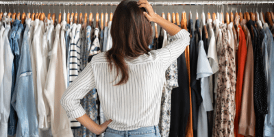Donna indecisa davanti a numerose opzioni di acquisto in un negozio e consumatrice che osserva una vasta scelta di prodotti sugli scaffali di un supermercato, simbolo del paradosso della scelta.