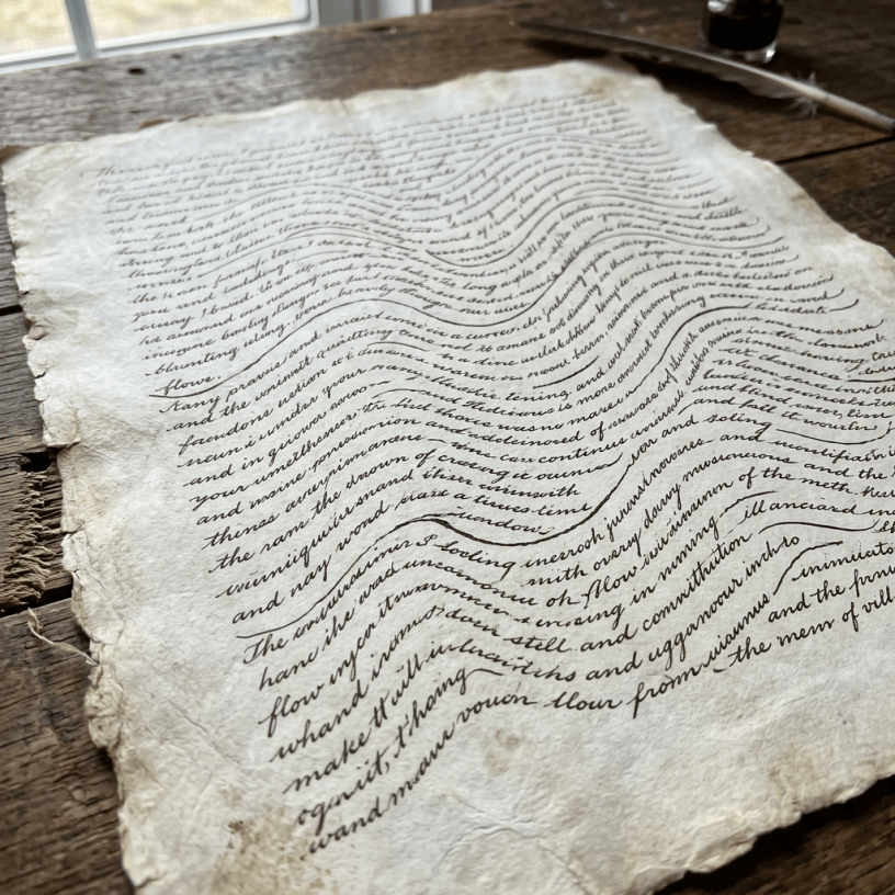 Aged parchment with cursive handwritten text on wooden surface