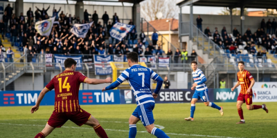 Pro Patria player dribbling past AC Reggiana defender during soccer match