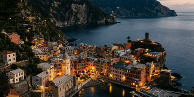 Vernazza village and harbor beneath steep coastal cliffs at dusk