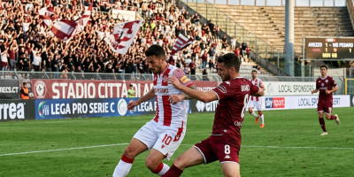 Two soccer players contest the ball during a Serie C match