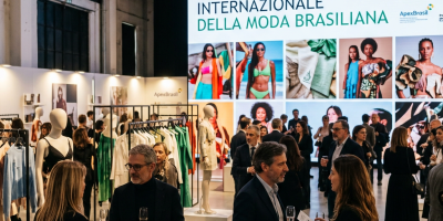 Guests viewing Brazilian fashion displays beneath an APEXBrasil presentation screen